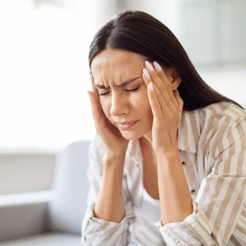 Woman experiencing jaw pain while chewing – Chiropractor Melbourne