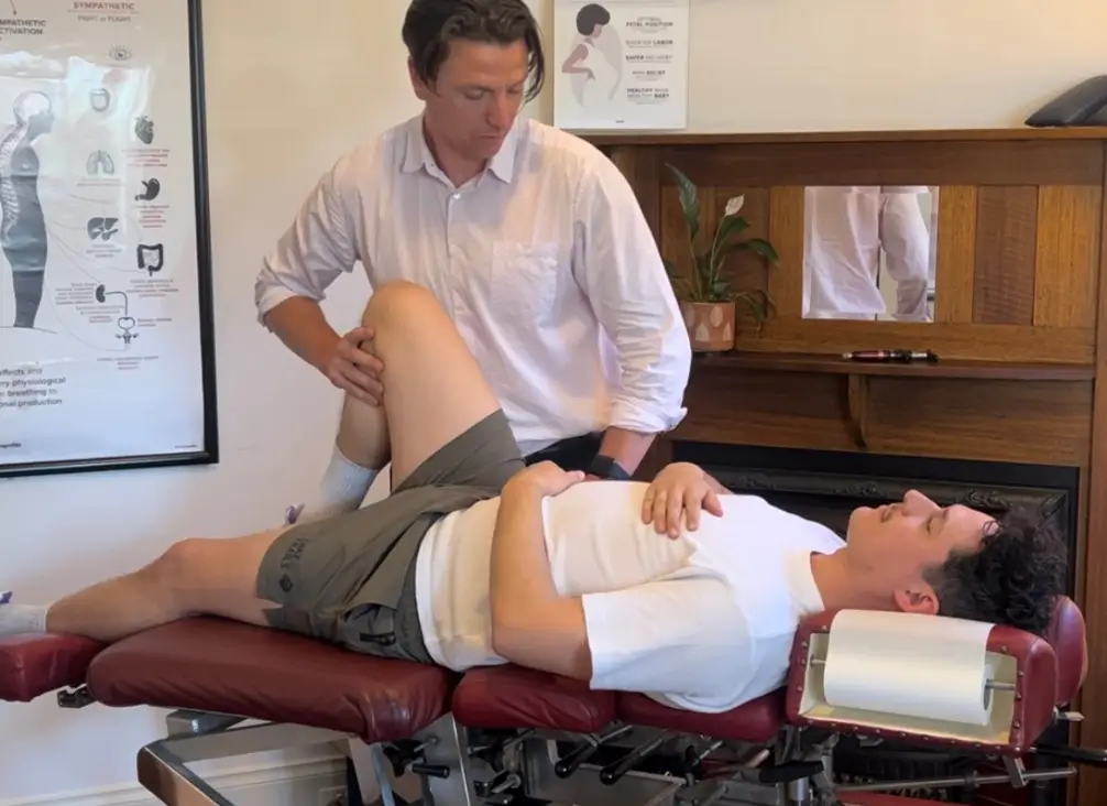 Chiropractor Melbourne treating knee pain with manual therapy
