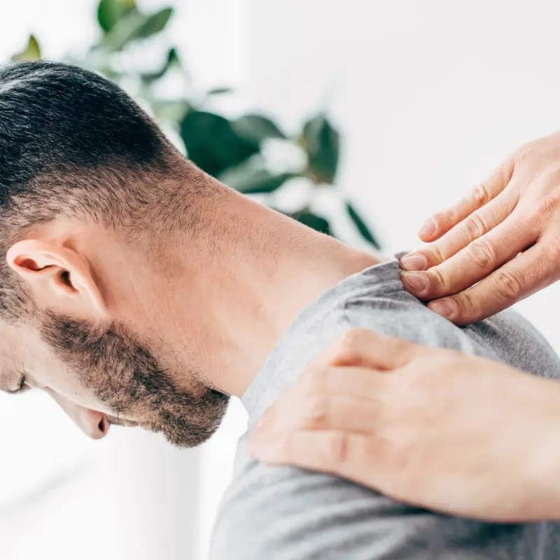 Chiropractor Melbourne providing hands-on neck pain treatment for a male patient