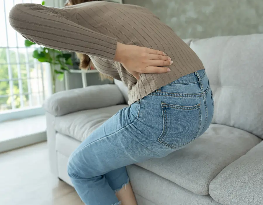 Woman with lower back pain needing Chiropractor Melbourne for sciatica